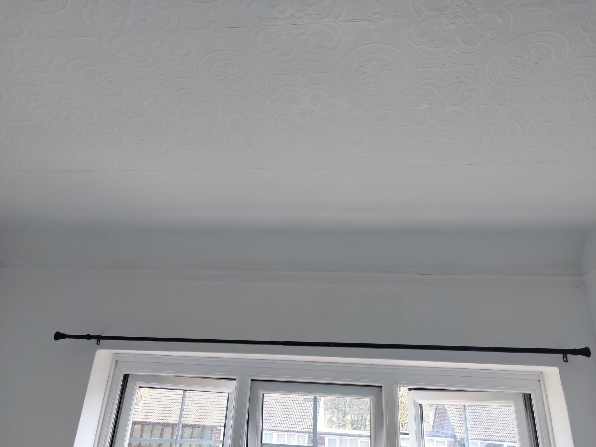 Clean ceiling and wall above a window after cleanup